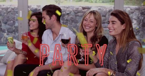 Joyful Friends Celebrating at Home with Drinks and Confetti