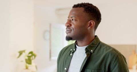 Pensive African American Man Relaxing in Modern Home