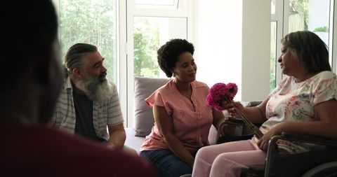 Group support with woman in wheelchair sharing moment