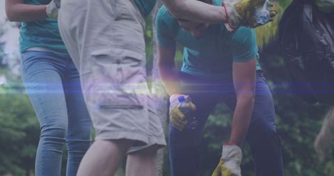 Volunteers collecting litter in countryside for eco conservation