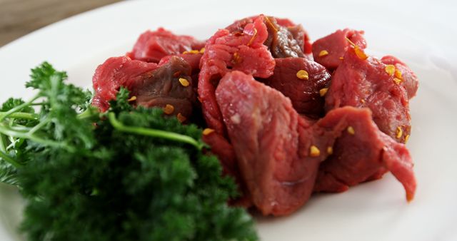 Close-up of Fresh Sliced Beef with Parsley on White Plate - Download Free Stock Images Pikwizard.com