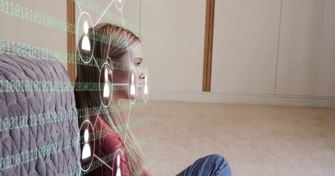 Young woman sitting by couch with virtual social network overlay and flowing binary code