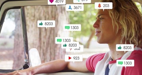 Young driver engaging with social media notifications outdoors