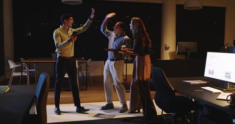 Diverse Team Collaborating in Office During Night Meeting