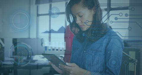 Businesswoman using digital tablet with abstract graph and circuit overlay