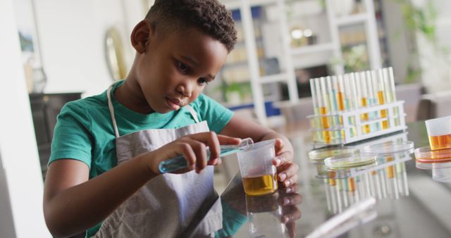 Image of african american boy doing experiments at home. Childhood, education, spending time at home concept.