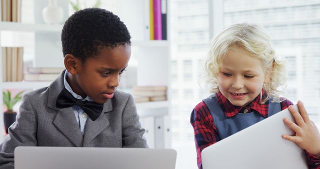 Two Children Engaging with Technology in Classroom - Download Free Stock Images Pikwizard.com