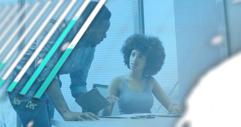 Colleagues Discussing Work with Financial Data Overlay in Office