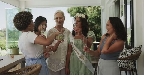 Diverse Group of Women Celebrating Bridal Shower with Champagne Toast