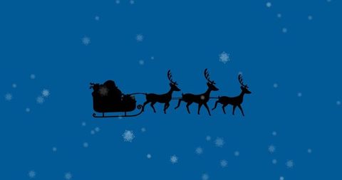 Silhouette of Santa's Sleigh with Reindeer Against Blue Winter Sky
