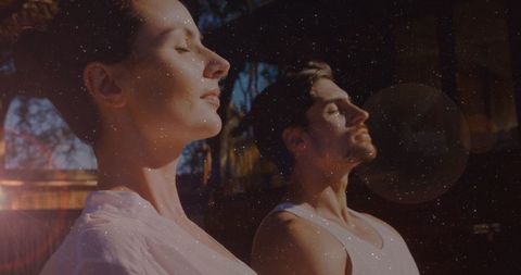 Couple Meditating Outdoors with Digital Light Effects