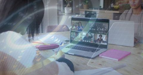 Student Taking Notes During Virtual Math Class at Home Kitchen Table