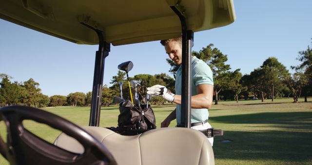 Male golf player removing golf club from golf bag at golf course