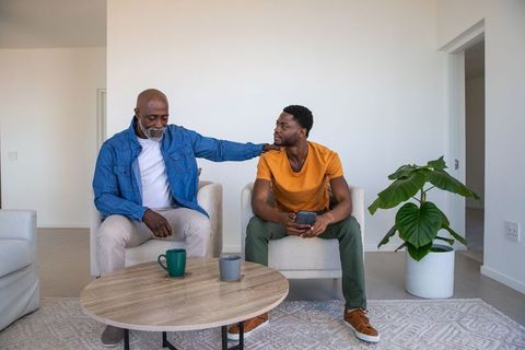 Father and Son Bonding Over Smartphone in Living Room Setting