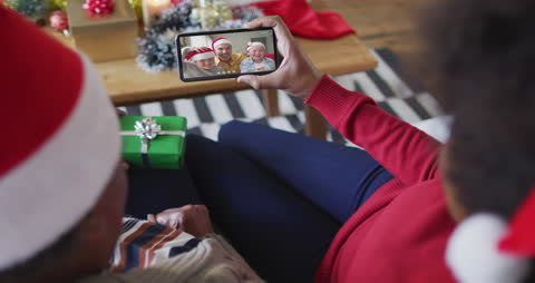 Couple Enjoying Christmas Video Call with Relatives on Smartphone