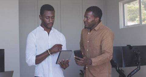 Business Professionals Collaborating with Tech in Modern Office