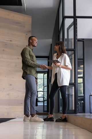 Business Partners Shaking Hands in Modern Office Lobby