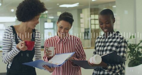 Diverse Colleagues Collaborating with Documents and Coffee in Office