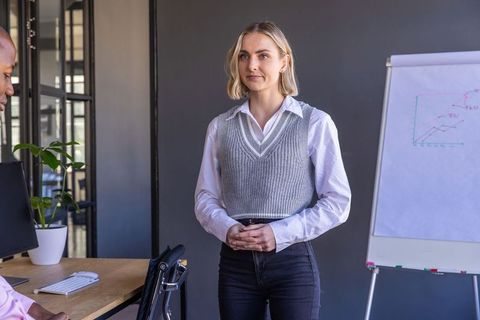 Business Professionals Discussing Sales Strategies in Modern Office