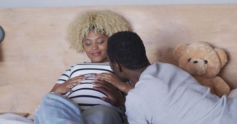 Expectant Parents Embracing Bond with Unborn Child in Cozy Moment