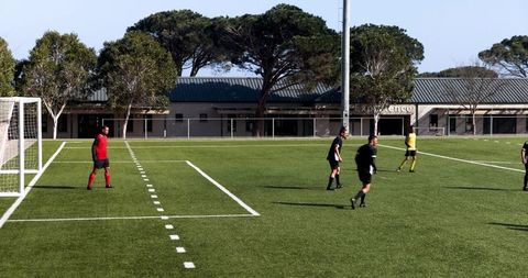 Soccer Players Engage in Strategic Practice on Sunny Day