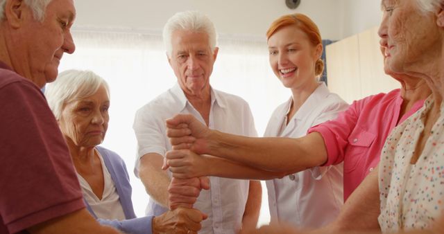 Group of senior people and therapist putting their fist together while exercising 