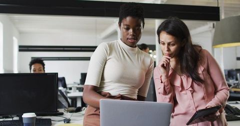 Focused Diverse Businesswomen Collaborating in Modern Office Environment