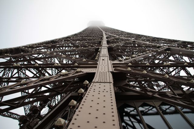 Looking Up at Eiffel Tower in Foggy Weather - Download Free Stock Photos Pikwizard.com