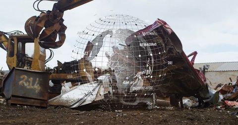 Excavator lifting crushed car at scrapyard with digital overlay