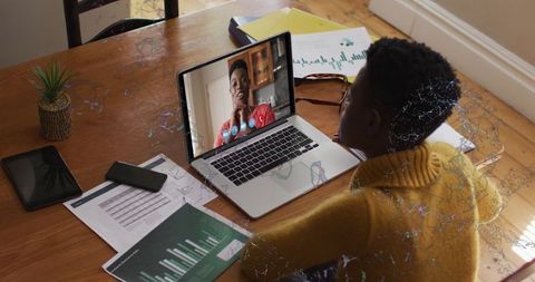 Virtual Team Meeting in Modern Workspace with Printed Reports