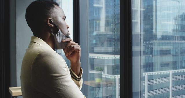 Pensive Businessman Wearing Mask Looking out Window During Workday - Download Free Stock Images Pikwizard.com