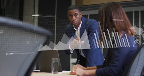 Business Team Analyzing Digital Data with Projected Graphs in Office