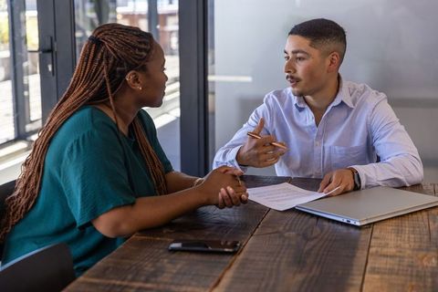 Diverse Coworkers Collaborating in Modern Office at Conference Table
