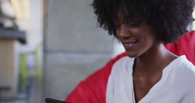 Young woman smiling while using tablet - Download Free Stock Images Pikwizard.com