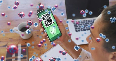 Woman displaying qr code covid-19 health pass on smartphone