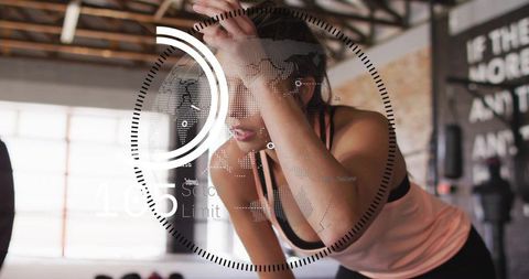 Woman pausing during intense gym workout with futuristic hud fitness metrics overlay