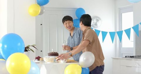 Friends Celebrating Birthday With Snacks and Balloons at Home