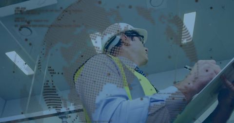 Engineer analyzing digital blueprints in industrial plant