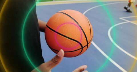 Athlete spinning basketball on finger in dynamic motion shot
