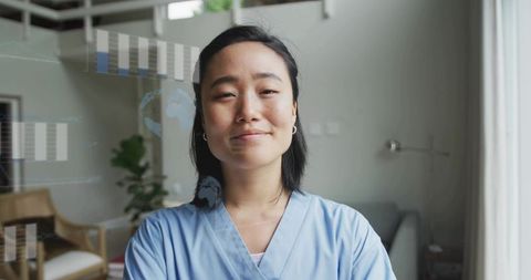 Confident medical professional in scrubs presenting virtual health data and global charts