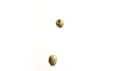 Olives Cascading Gracefully Against White Background