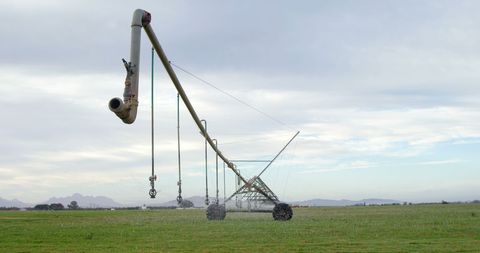 Medieval trebuchet launching projectile in vast open field
