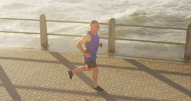 Senior Man Jogging Near Sea at Sunrise - Download Free Stock Images Pikwizard.com