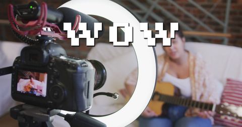 Woman vlogging while playing guitar with professional setup