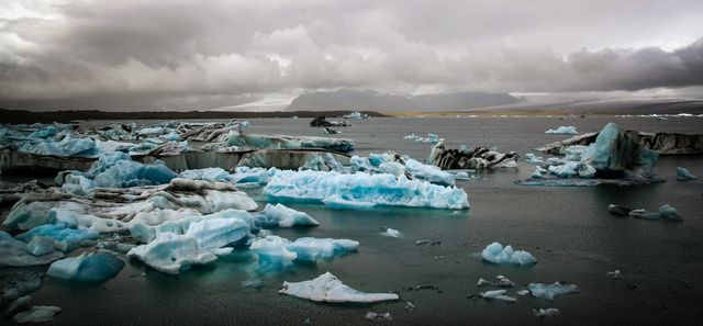 Melting Icebergs in Icelandic Lagoon with Cloudy Sky - Download Free Stock Photos Pikwizard.com