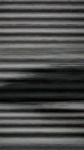 Vertical glitching coastal silhouette with flickering horizontal lines distorting shoreline