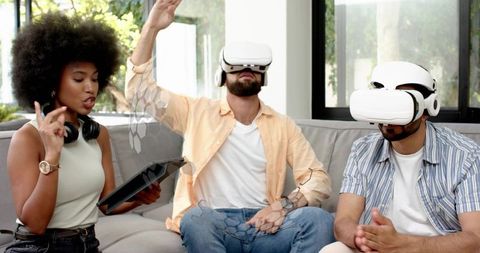Friends Testing Virtual Reality Headsets with Holographic Interface and Tablet in Living Room
