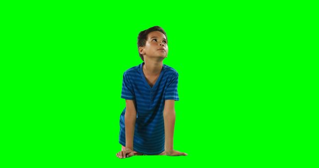 Young Boy in Blue Shirt Looking Up against Green Screen Background - Download Free Stock Images Pikwizard.com