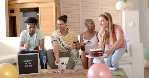Diverse friends celebrating new job with cake and champagne
