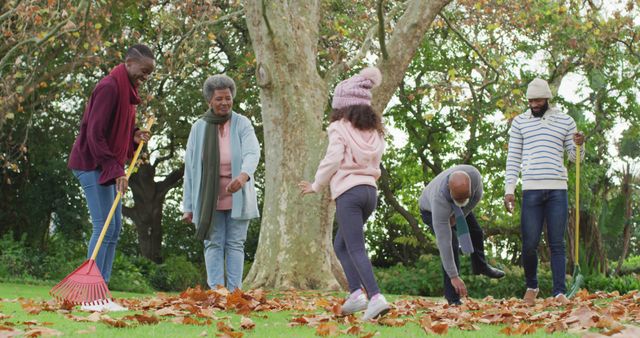 Image of happy african american parents and daughter collecting leaves with grandparents in garden. Family, domestic life and togetherness concept digitally generated image.